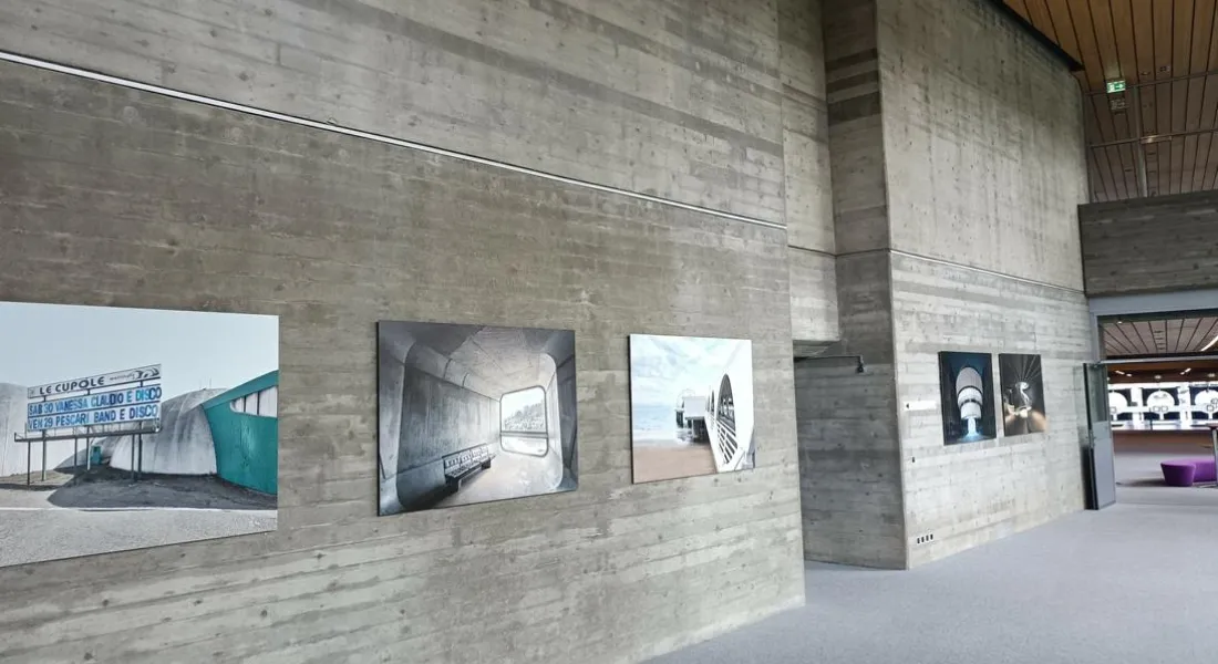 Fotogalerie in einem Raum mit hohen, rohen Betonwänden